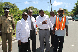(L-R) Assistant Commissioner of Police stationed on Nevis Robert Liburd, Prime Minister of St. Kitts and Nevis the Rt. Hon. Dr. Denzil Douglas, Premier of Nevis Hon. Vance Amory, Junior Minister in the Ministry of Communications and Works Hon. Troy Liburd and Chief Executive Officer of the Sugar Industry Diversification Foundation Terrence Crossman, with a worker on the Nevis Water Supply Enhancement Project Nevis along the Island Main Road while on a tour of ongoing works in the Project on October 08, 2014
